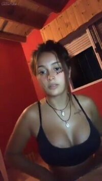 Busty young Spanish girl undresses on camera